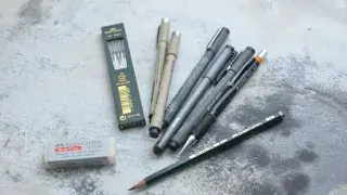 Collection of various pencils and markers used for graphic design and drawing techniques.