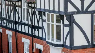 Traditional row of Tudor-style houses with timber framing in the UK