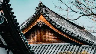 Traditional Japanese roof with intricate design and wooden structure.