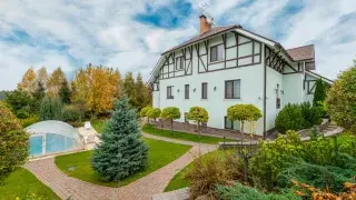 Tudor-style house with manicured garden and timber detailing