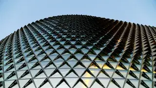 Modern glass and steel facade with repeating pattern.