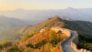 The Great Wall of China across green hills.