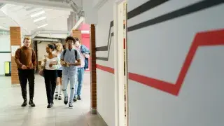 Students walking through a school hallway.