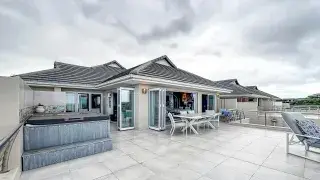 Modern house terrace with open design overlooking the ocean.