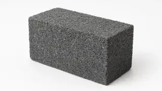 Recycled plastic brick with visible texture and multicolored flecks, showing sustainable construction material design.