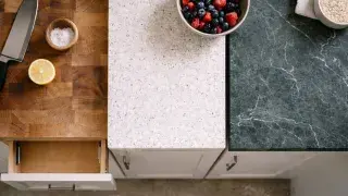 Three common kitchen benchtop materials shown side-by-side: wood, quartz, and marble.