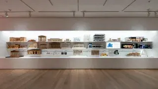 Museum exhibition showing architecture models and drawings from ancient classical forms to modern buildings.