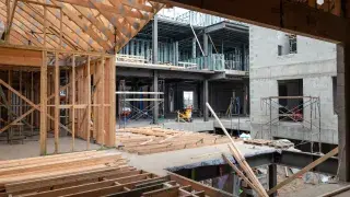 Wood, steel, and CMU building construction methods shown together on an active jobsite.