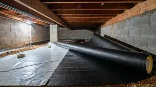 Crawl space vapor barrier materials compared by thickness inside a real crawl space.