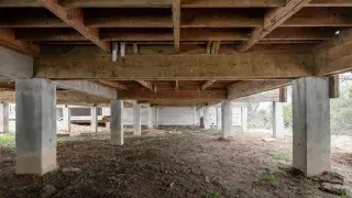 House under construction with a crawl space foundation, CMU walls, gravel base, and center support pier.