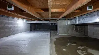 Crawl space showing normal humidity on one side and dangerous damp conditions on the other.