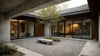 Modern siheyuan courtyard house with concrete frame, timber screens, sliding glass, and gravel court.