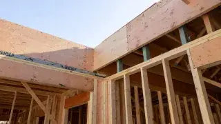 Wood framing at a diaphragm and wall intersection where a drag strut or collector zone is formed.