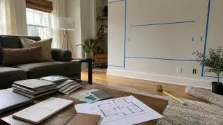 Interior design planning setup with room measurements, material samples, floor plan, and furniture layout.