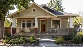 Old Craftsman house with front porch, wood trim, and early renovation work.
