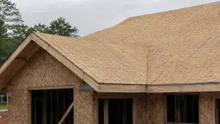Roof sheathing panels installed over rafters before underlayment and shingles.