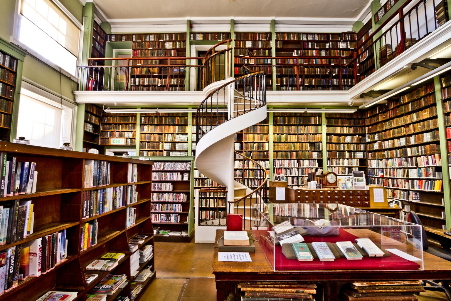Library shelves filled with architectural books and design resources.