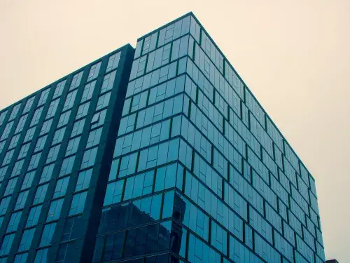Modern glass commercial building in a downtown area.