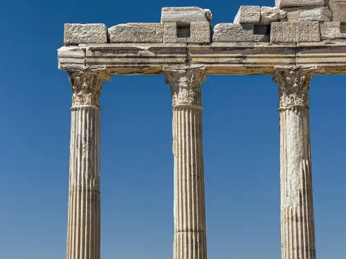 Ancient Greek ruins with standing Corinthian columns.