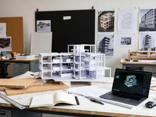 A working architecture studio desk showing physical massing models.