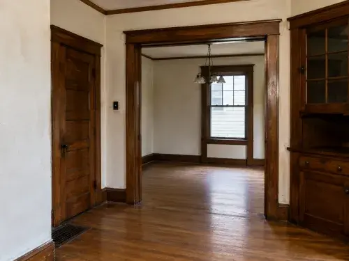 Original 1920s house trim, doors, floors, and plaster details worth saving.
