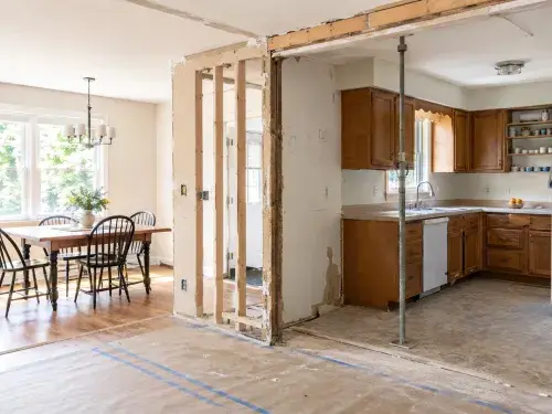 Kitchen and dining room wall opened during renovation with temporary support.