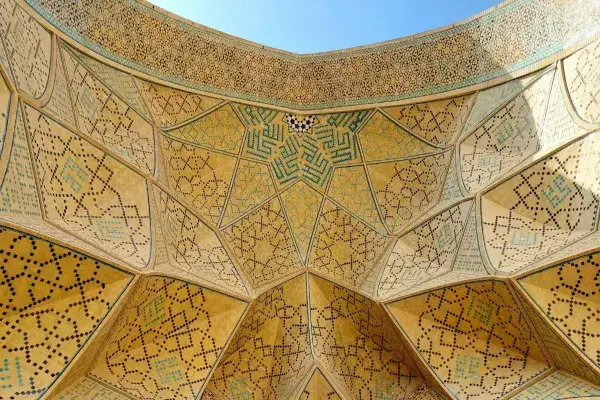 Close-up of an intricately ornamented ceiling in Islamic architecture.
