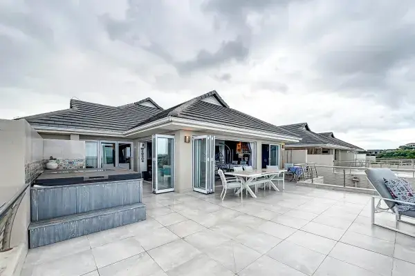 Modern house terrace with open design overlooking the ocean.