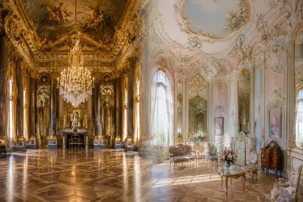 Lavish interior with Baroque and Rococo details including gilded moldings and frescoed ceilings.