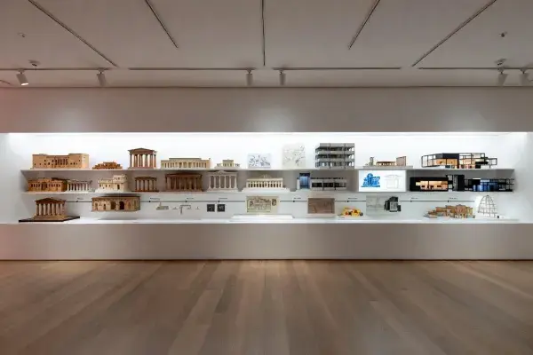 Museum exhibition showing architecture models and drawings from ancient classical forms to modern buildings.