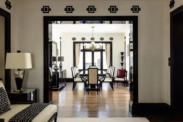 Art Deco-inspired interior with black trim, geometric detailing, and connected rooms flowing from one space to the next.