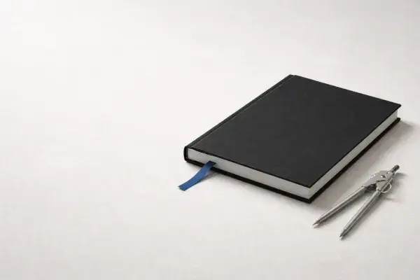 Graduate studies in architecture concept image with black portfolio, blue bookmark ribbon, and divider tool.