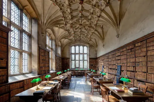 Gothic interior with pointed arches, vaulted ceiling, and long reading-room character.