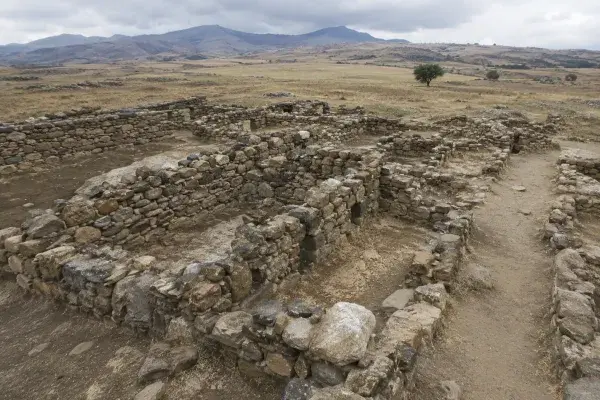 Early stone settlement walls in a dry archaeological landscape.