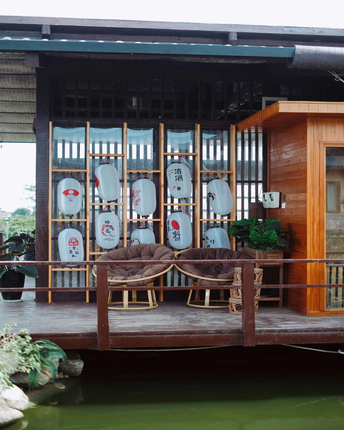 Cozy Japanese-style porch with lanterns and chairs, overlooking the courtyard.
